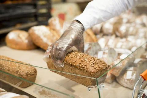 Hand holding bread blurred background 스톡 사진