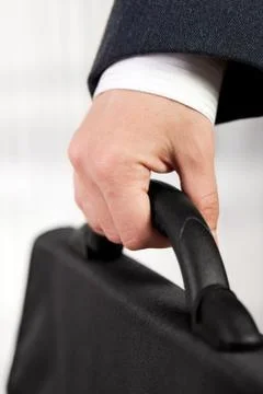 Hand holding briefcase Stock Photos