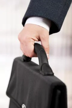Hand holding briefcase Stock Photos