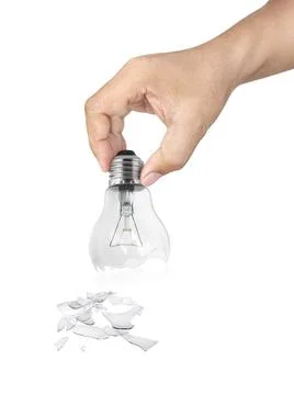 Hand holding Broken light bulb isolated on white background Stock Photos
