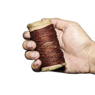 Hand Holding Brown Thread Spool White Background 스톡 사진