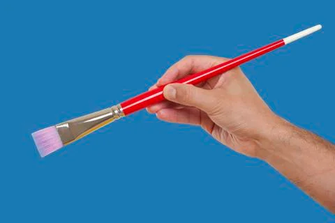 Hand holding a brush Stock Photos