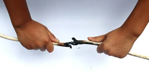 Hand holding, burn, damaged cable. Stock Photos