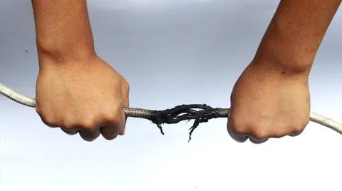 Hand holding, burn, damaged cable. The power cord broke due to fire Stock Photos