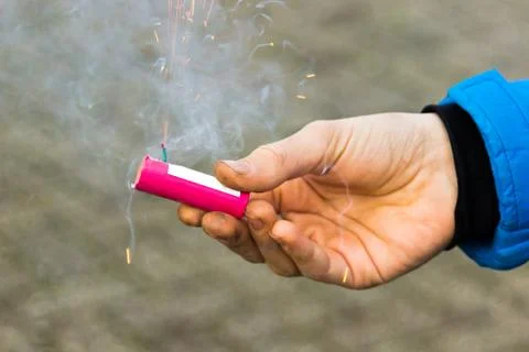 Hand holding burning firework Stock Photos