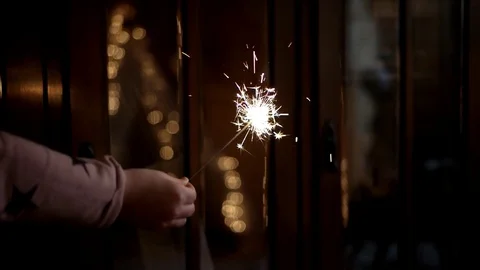 Hand Holding a Burning Sparkler Stockbeeldmateriaal 71788245