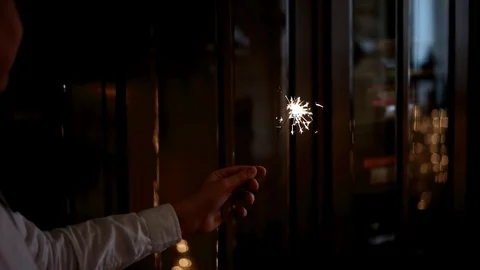 Hand Holding a Burning Sparkler Stock Footage 71788293