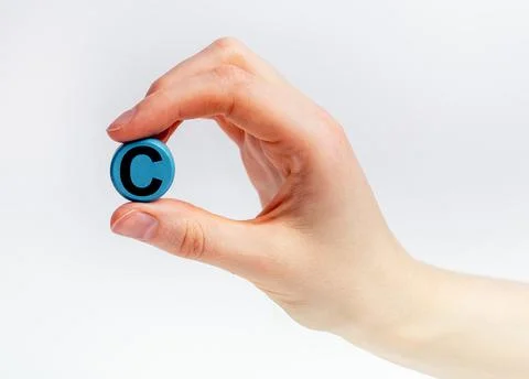 Hand holding C vitamin, ascorbic acid pill close up Stock Photos