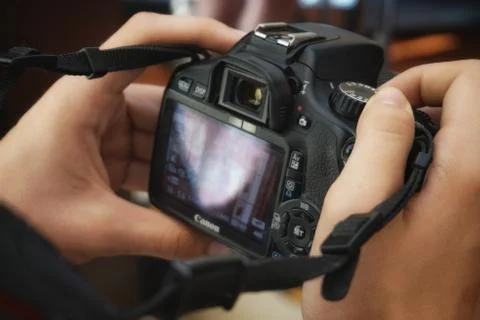 A hand holding a camera Stock Photos