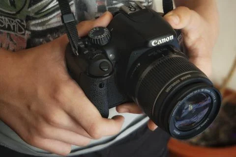 A hand holding a camera Stock Photos