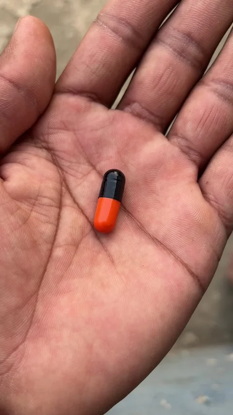 Hand Holding a Capsule Close-Up | 4K Vertical Health Footage Stock-Footage 321629821