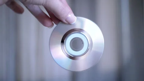 Hand Holding CD Against Light Stock Footage 312010795