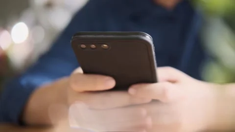 A hand holding a cell phone 库存影片 156848732