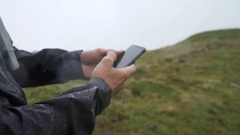 Hand holding a cellphone and tapping on screen close up, slow motion Stock Footage 129610343