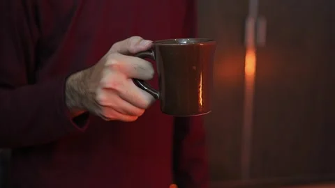 Hand holding a ceramic coffee mug with matte finish Video stock 337847474