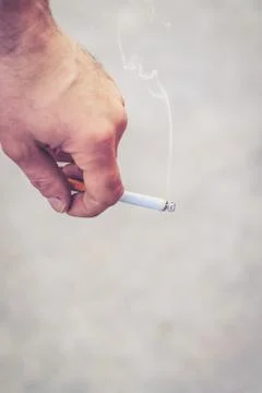 Hand holding cigarette Stock Photos