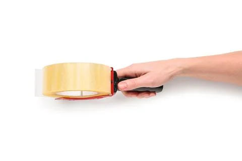 Hand holding clear packaging tape dispenser for shipping and moving boxes, is Stock Photos