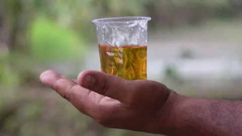 A hand holding a clear plastic cup Stock Footage 316235706
