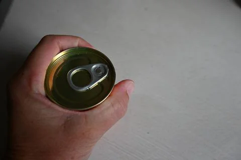 Hand holding a closed can Stock Photos