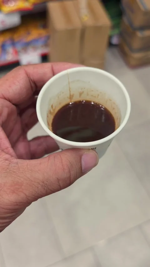 A hand holding a coffee cup while shopping in a modern supermarket Stock Footage 341554427
