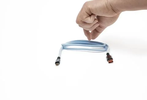 Hand holding coiled blue electrical cable with USB connectors Stock Photos
