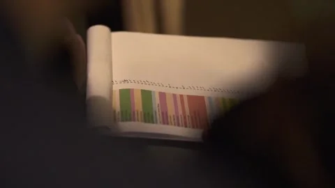 Hand holding a color-coded event planning book list, detailed and Stock Footage 278398540