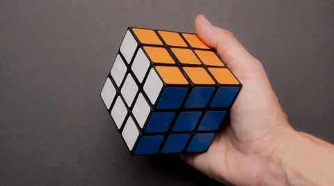 Hand holding a colored game cube Stock Photos