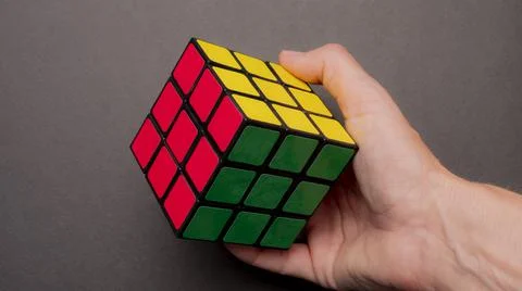 Hand holding a colored game cube Stock Photos