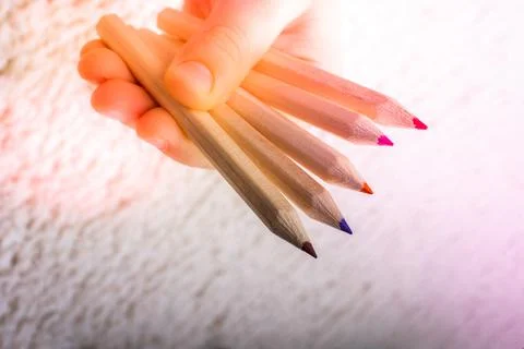 Hand holding colored pencils for creative idea and concept. Stock Photos