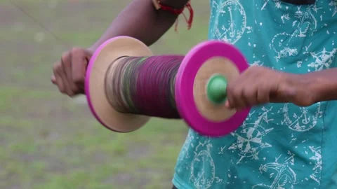 Hand holding colorful kite string spool Stock Footage 320016249