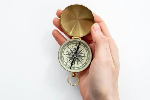 Hand holding compass. Best solution or direction concept Photos
