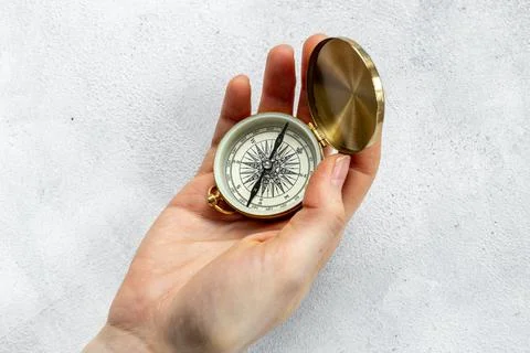 Hand holding compass. Best solution or direction concept Photos