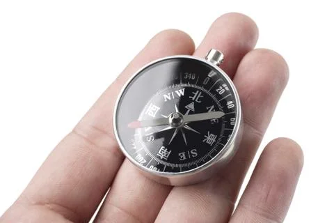 Hand holding the compass close up shoot Stock Photos