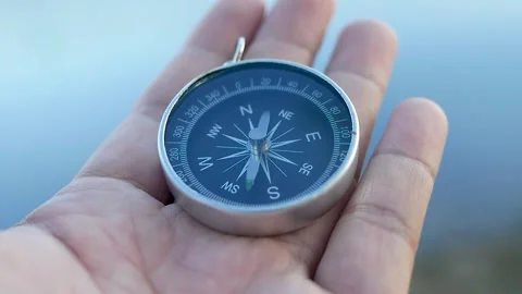 A hand holding a compass 库存影片 156847442