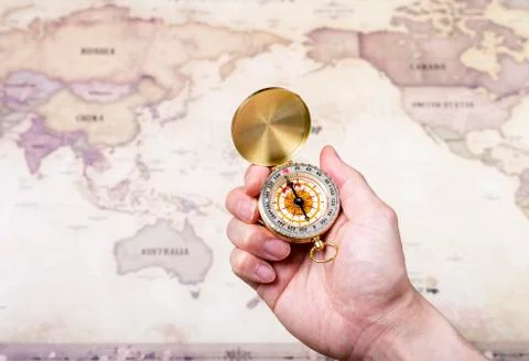 A hand holding a compass Stock Photos