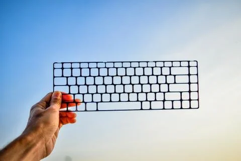 Hand holding computer keyboard for communication technology concept,Technolog Stock Photos