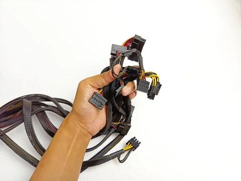 Hand Holding Computer Power Supply Cables and Connectors Photos