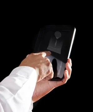 Hand holding computer tablet with black background 写真素材