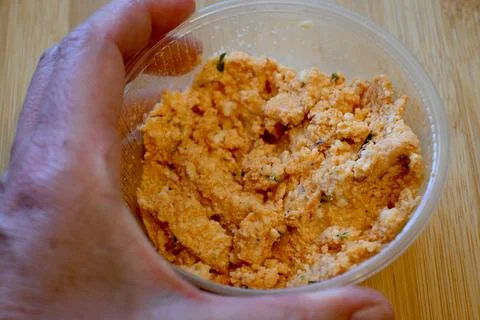 Hand holding container with cheese spread Fotos Stock