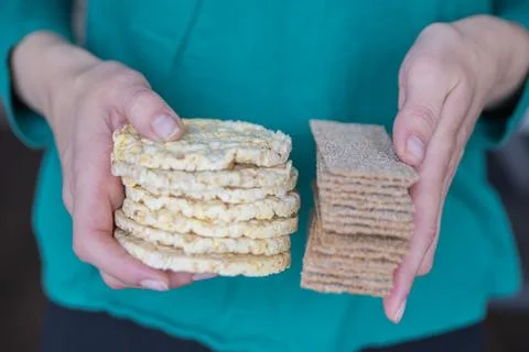Hand holding corn chips close-up. Round yellow chips are a quick snack for kids. Stock Photos