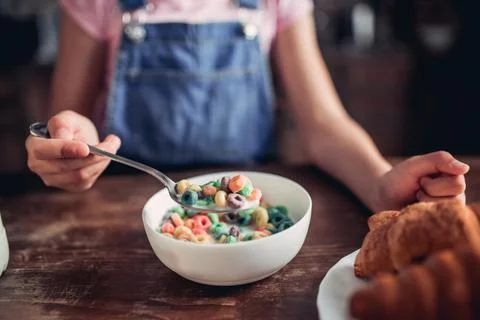 Hand holding corn flakes on the spoon Stock Photos