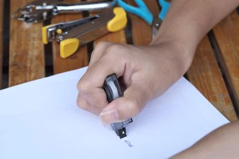 Hand holding corrector. Stock Photos