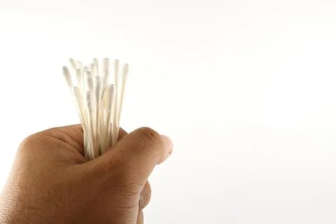 Hand holding cotton bud Stock Photos