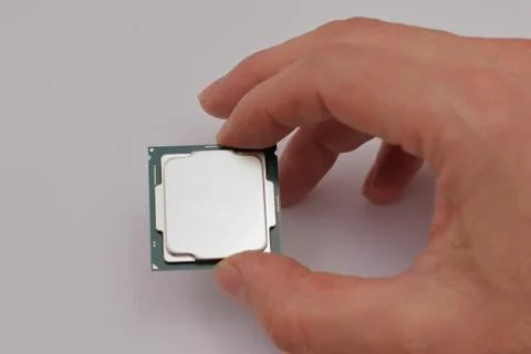Hand holding a CPU Photos