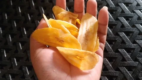 Hand Holding Crispy Banana Chips Snacking Stock Footage 340618598