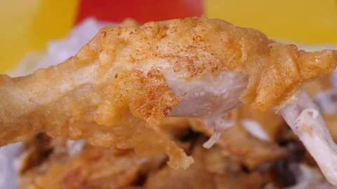 Hand Holding Crispy Fried Chicken Drumstick Stock-Footage 343587940