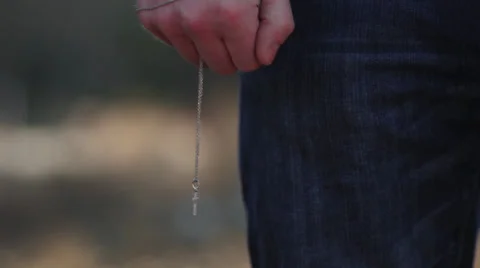 Hand holding Cross on Chain, MS Stock-Footage 33695585