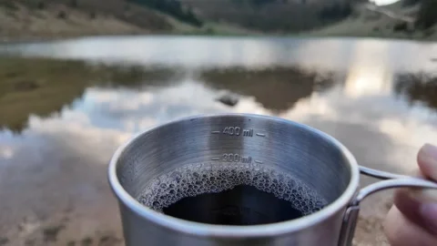 A hand holding a cup filled with tea. Stock Footage 317679328