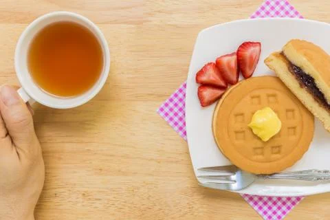 Hand Holding Cup of Tea Stock Photos