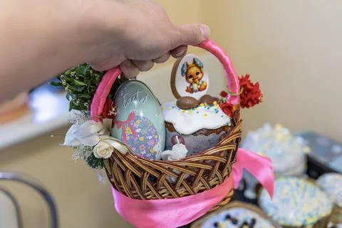 Hand Holding Decorated Children's Easter Basket with Bunny Cookie Stock Photos